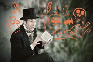 Storyteller Chris Connaughton reading with Halloween illustrations over the image