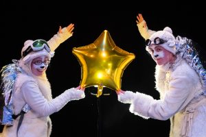 The Polar Bears Go Up. The Polar Bears holding a gold foil balloon star