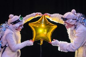 The Polar Bears Go Up. The Polar Bears holding a gold foil balloon star