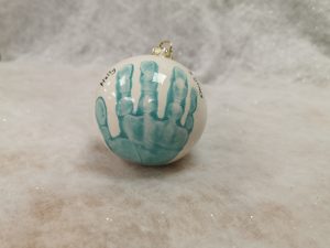 Bauble with handprint on a table
