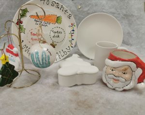 Festive craft items on a table. Mugs and Plates