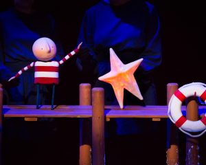 Boy puppet catching a star