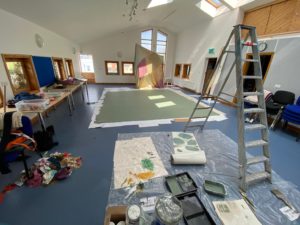 Painting the dancefloor at Travelling Light Theatre Company venue 